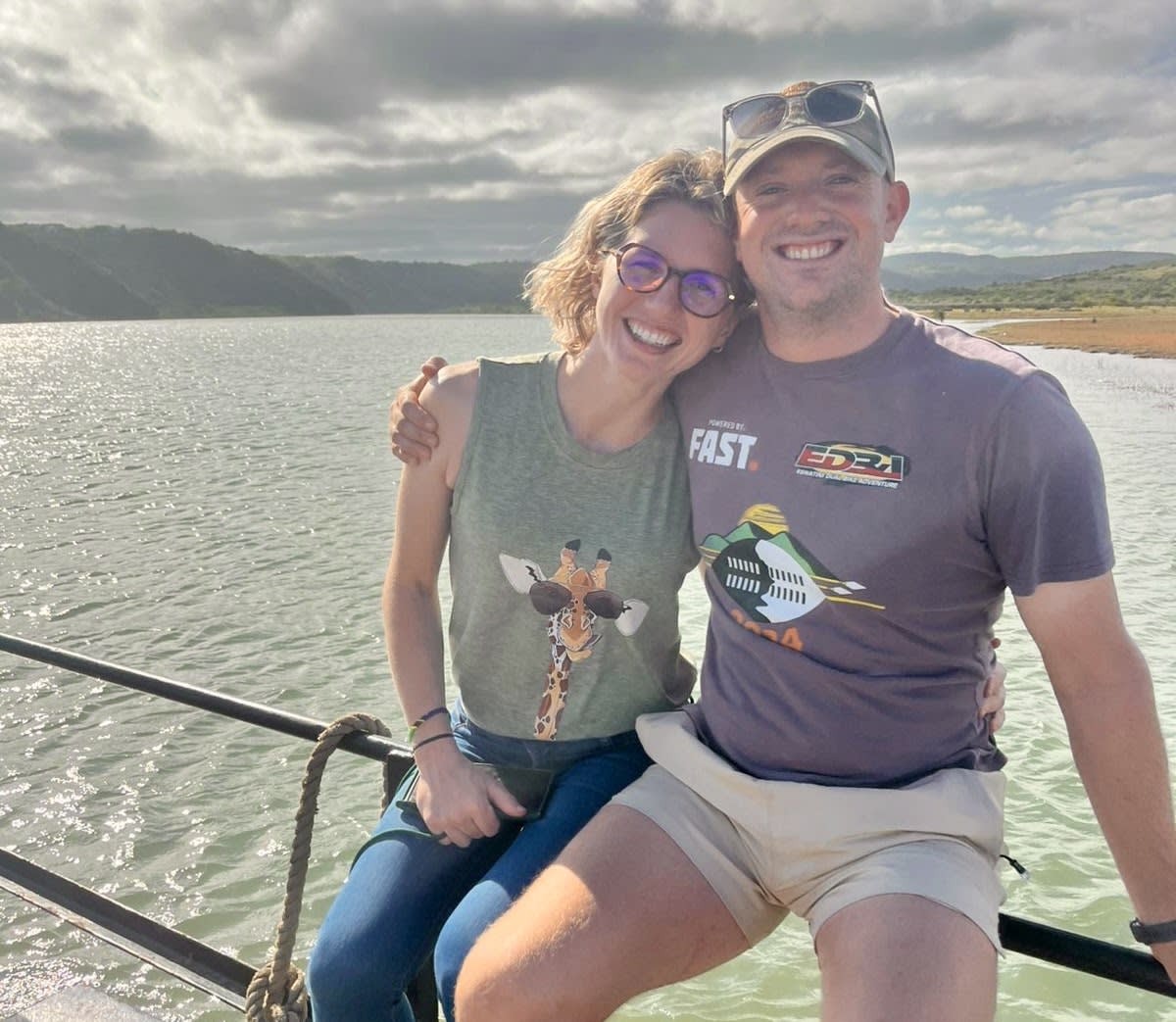 Anneli and Matthew — owners of Kanaan Guest Farm since August 2025 — on the dam, laughing, the Lowveld behind them.